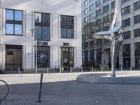 a skateboarder is riding in the middle of a city square of various buildings