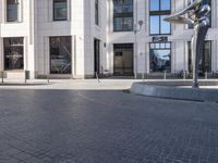 a skateboarder is riding in the middle of a city square of various buildings