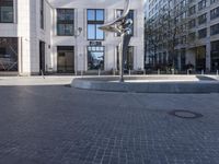 a skateboarder is riding in the middle of a city square of various buildings