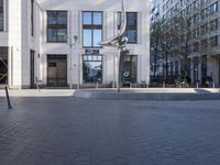 a skateboarder is riding in the middle of a city square of various buildings