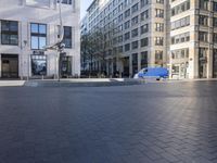 a skateboarder is riding in the middle of a city square of various buildings