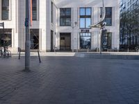 a skateboarder is riding in the middle of a city square of various buildings