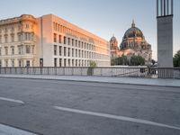 street scene with man skateboarding with an old cathedral in the background at sunset, and buildings in the distance