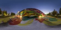 a skateboarder is riding down the ramp in front of an art installation of a giant flower