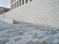 a person is on a skate board near some buildings with brick walls in front of them