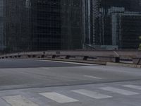 a man riding his skateboard on the street between large buildings in a city with a woman on a bench