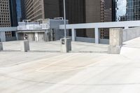 a skateboarder is on top of the cement area in a city setting with many skyscrapers