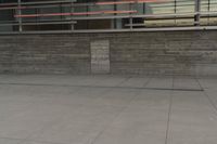 a man riding a skateboard through a cement covered parking lot under a building on a city street