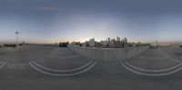 a skateboarder is doing a trick on a ramp in the middle of a city at dusk