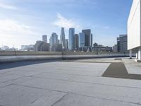 a man that is holding a skateboard up to a wall in the city of skyscrapers