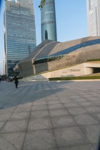 a stone building has a modern style architecture in it's centerpiece, as seen from the plaza