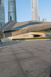 a stone building has a modern style architecture in it's centerpiece, as seen from the plaza