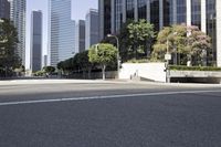 a man riding his skateboard down a street past tall buildings, in the city