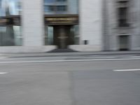 a man rides his skateboard down the sidewalk in a blurry photo for commercial use