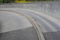 man on skateboard in mid air at the top of a concrete ramp along side the river