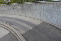 man on skateboard in mid air at the top of a concrete ramp along side the river