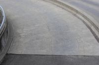 man on skateboard in mid air at the top of a concrete ramp along side the river