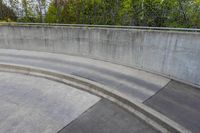 man on skateboard in mid air at the top of a concrete ramp along side the river