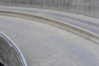 man on skateboard in mid air at the top of a concrete ramp along side the river