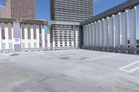 a person is skateboarding on the concrete roof of a building, with tall buildings behind them