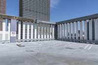 a person is skateboarding on the concrete roof of a building, with tall buildings behind them