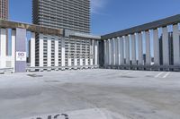 a person is skateboarding on the concrete roof of a building, with tall buildings behind them