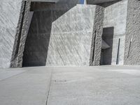 a person skateboarding in front of a wall that is partially made out of concrete