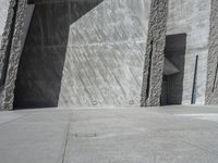 a person skateboarding in front of a wall that is partially made out of concrete