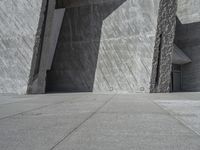 a person skateboarding in front of a wall that is partially made out of concrete