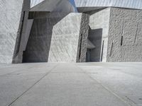 a person skateboarding in front of a wall that is partially made out of concrete