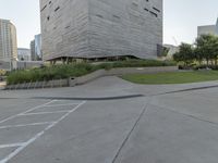 a person on a skateboard in a city square next to the building that is a library