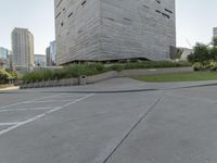 a person on a skateboard in a city square next to the building that is a library