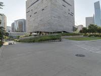 a person on a skateboard in a city square next to the building that is a library