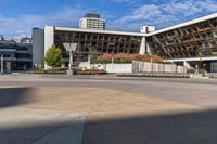 a red skateboarder riding a skate ramp in the middle of an empty city