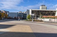 a red skateboarder riding a skate ramp in the middle of an empty city