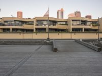 a person is skateboarding in an empty city courtyard on the street with a building on both of them and another building in the background