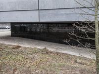 a man riding a skateboard down a path on top of a cement slab in front of a building