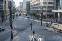 a man riding a skateboard down the middle of a street near buildings and steps