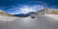 an upside down picture of a man riding his skateboard on a highway through mountains