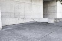 an image of a man on a skateboard in front of concrete wall with stairs