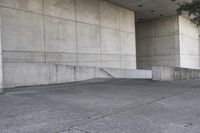 an image of a man on a skateboard in front of concrete wall with stairs