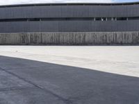 the skateboarder is practicing his tricks in an empty area of concrete and cement