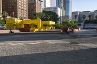 a man skateboarding near some yellow buildings on a sunny day in the city with people