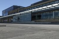 a person riding a skateboard on top of a sidewalk next to a train station