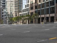 a person on a skateboard riding past tall buildings in the background in a city