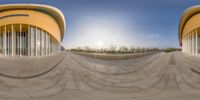 a skateboarder rides the side of a building with a circular roof and yellow walls