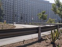 an image of some people skate boarding in the street corner of a city with large buildings