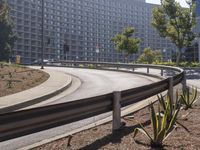 an image of some people skate boarding in the street corner of a city with large buildings