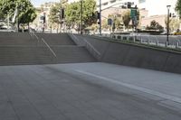 a boy is skateboarding down a concrete sidewalk by stairs and trees outside an office building