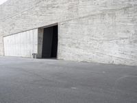 the man is riding his skateboard near some wall space in the middle of nowhere